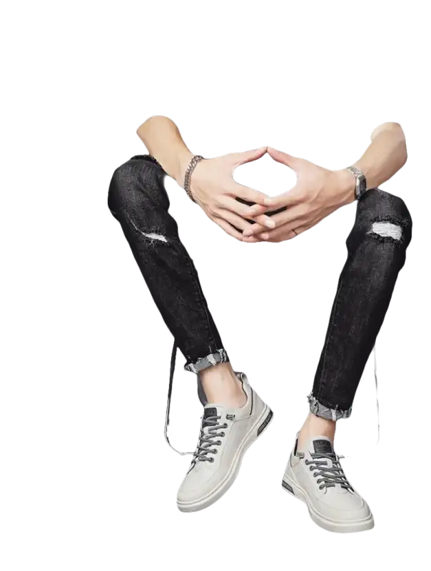 Man in black ripped jeans and gray sneakers.