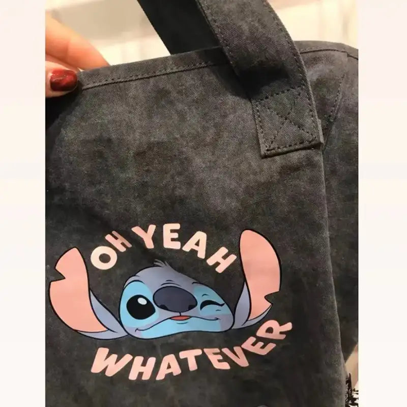 Gray tote bag with Stitch graphic.