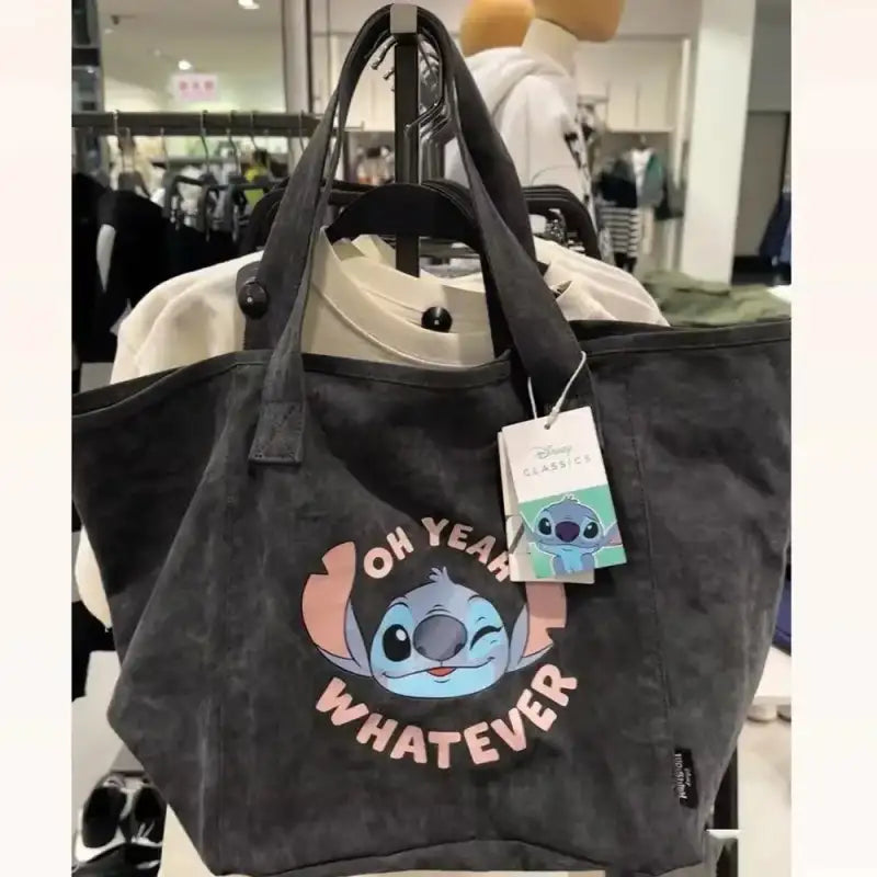 Gray tote bag with Stitch graphic.