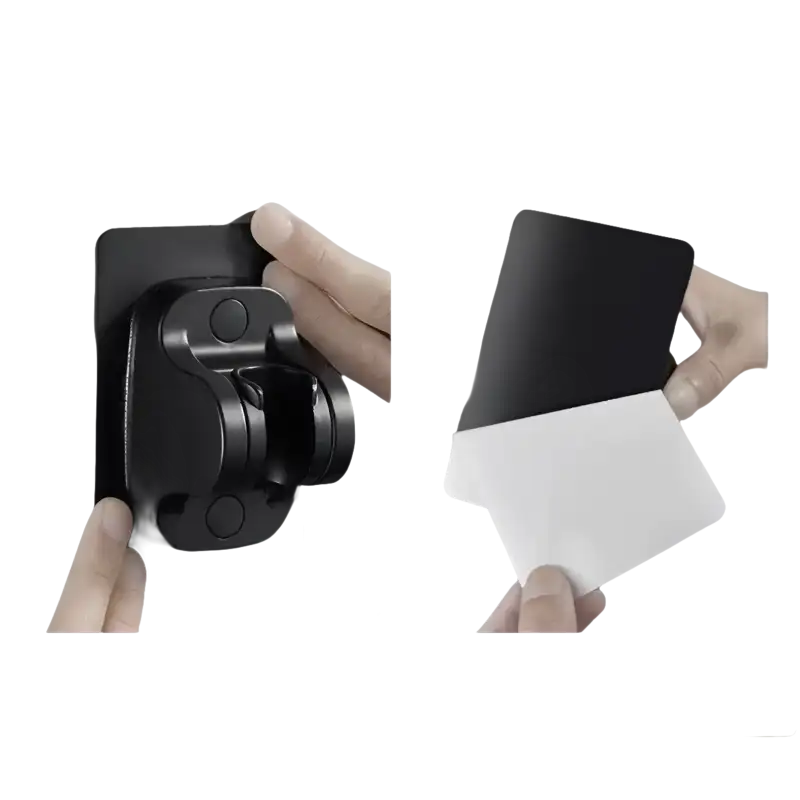 Black shower head holder with adhesive backing.