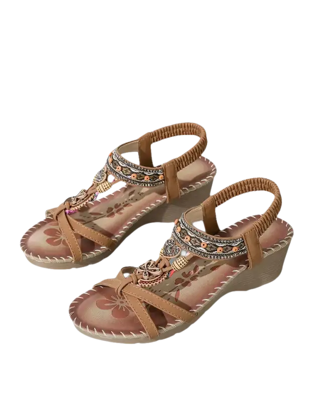 Tan wedge sandals with beaded embellishments.