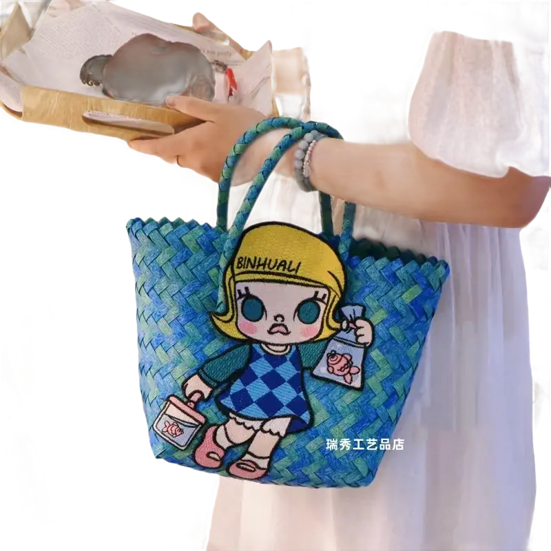 Blue woven tote bag with cartoon patch.