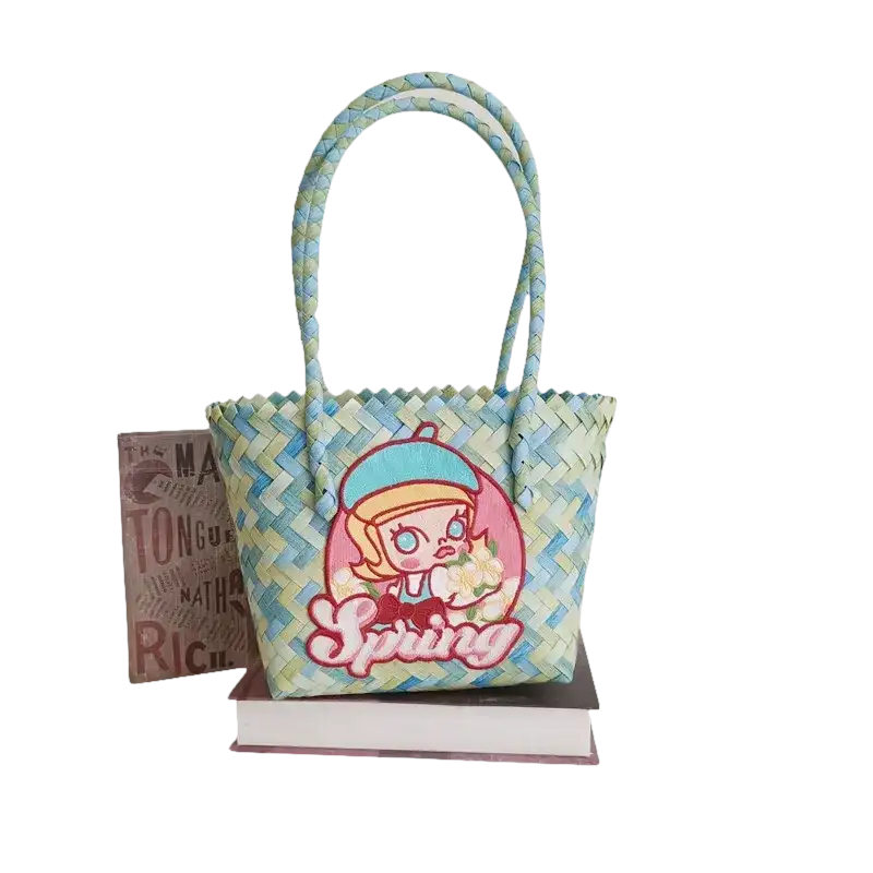 Woven blue and green tote bag with cartoon girl.