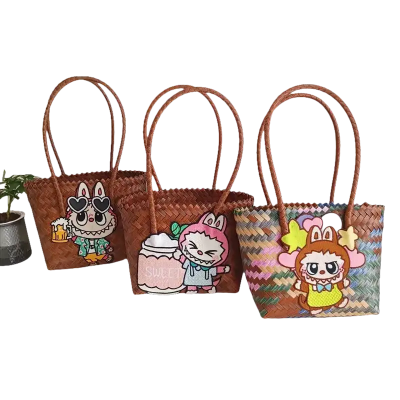 Three woven tote bags with cartoon character embellishments.