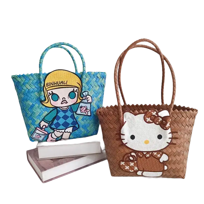 Two woven tote bags with cartoon appliqués.