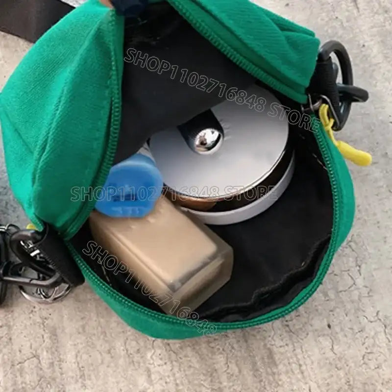 Green pouch with cosmetics.