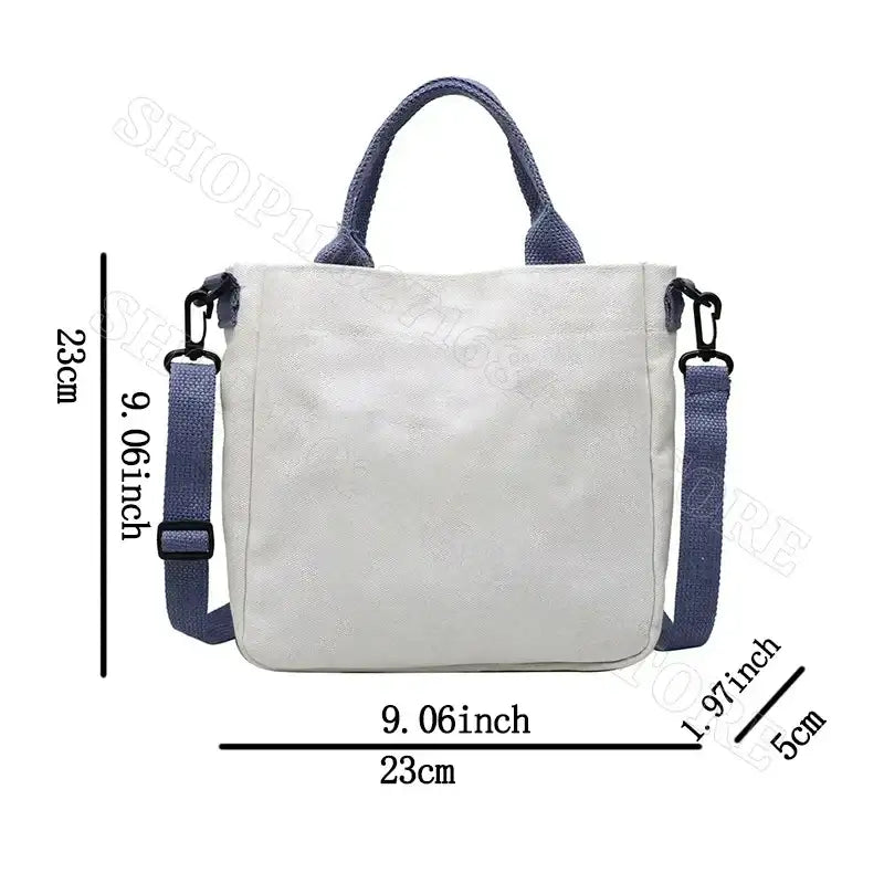 White tote bag with blue handles and strap.