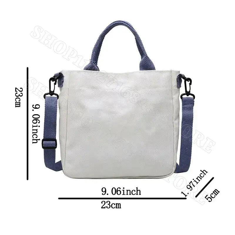 White tote bag with blue handles and strap.
