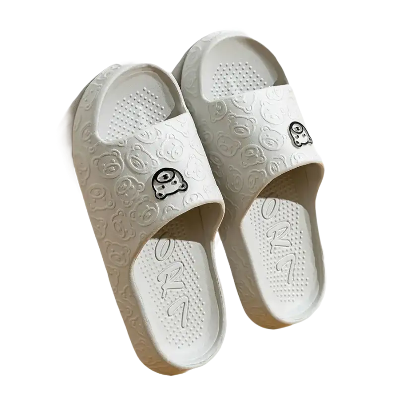 Pair of gray cartoon-patterned slide sandals.