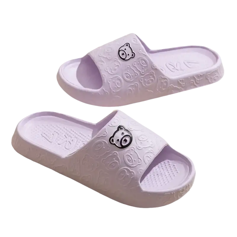 Pair of lavender bear-themed slide sandals.