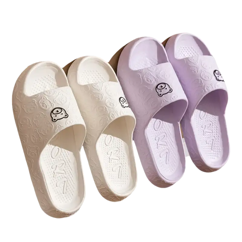 White and purple cartoon-themed slippers.
