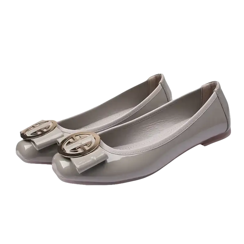 Gray patent leather ballet flats with gold buckle.