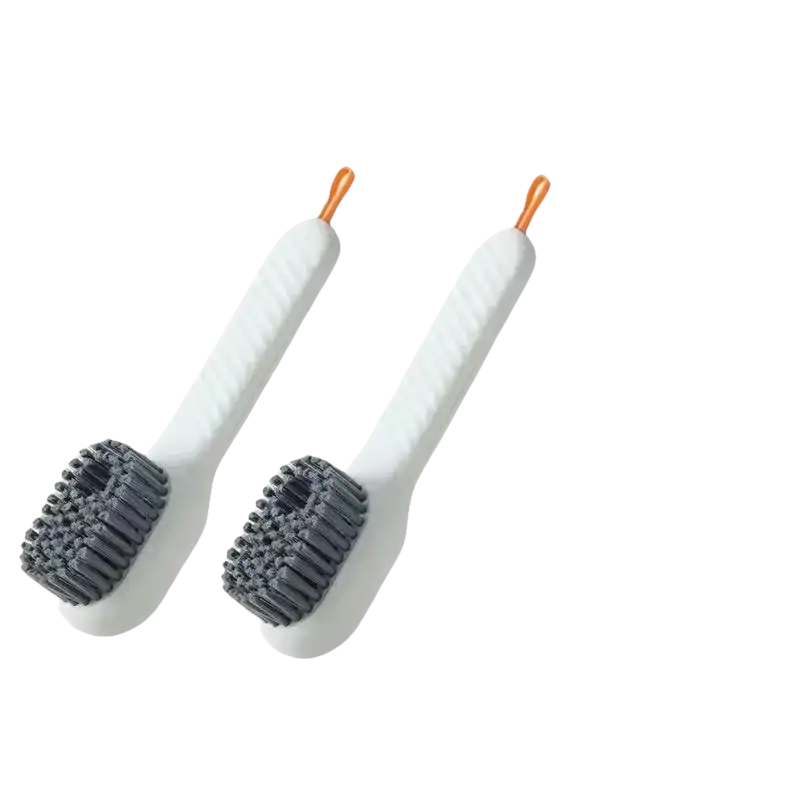Two white shoe cleaning brushes.
