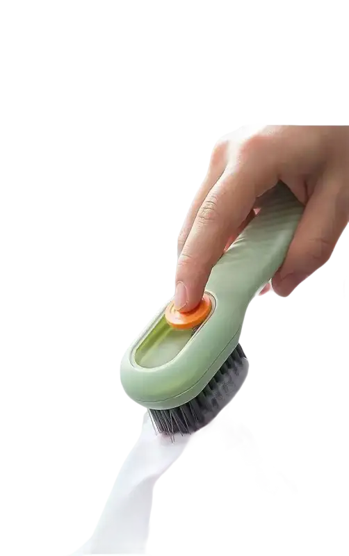 Green cleaning brush with orange button.