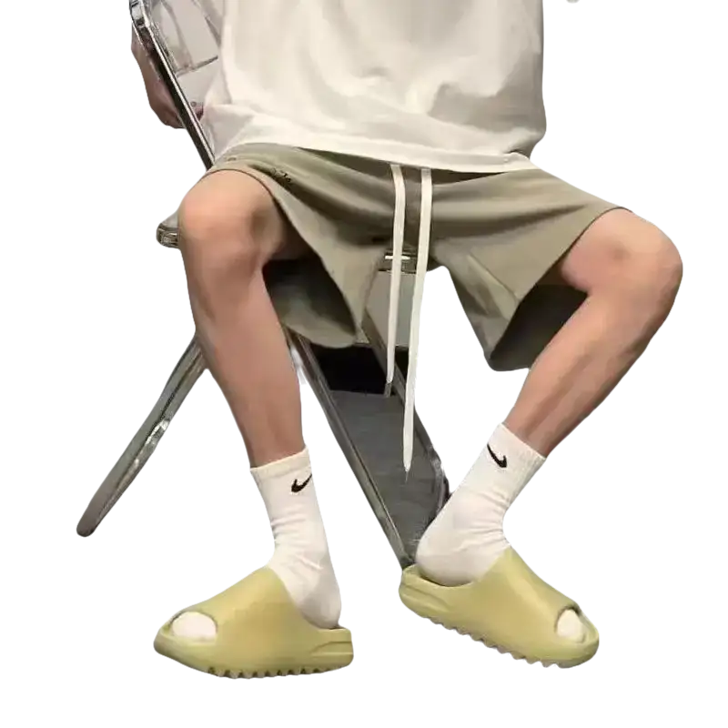 Person wearing slides and socks.