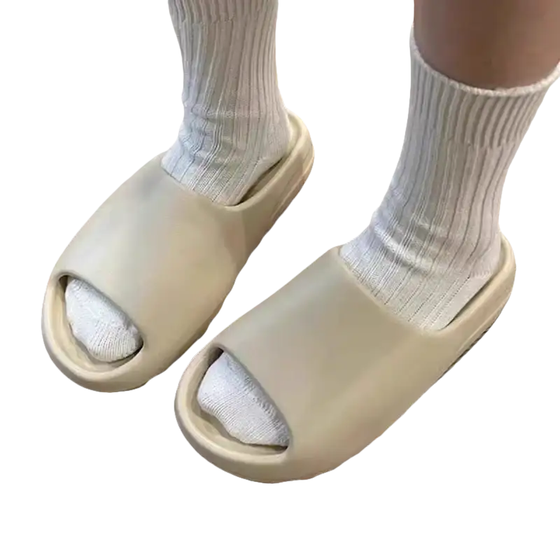 Beige slide sandals with white socks.