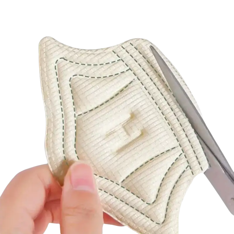 Beige quilted fabric pad with scissors.