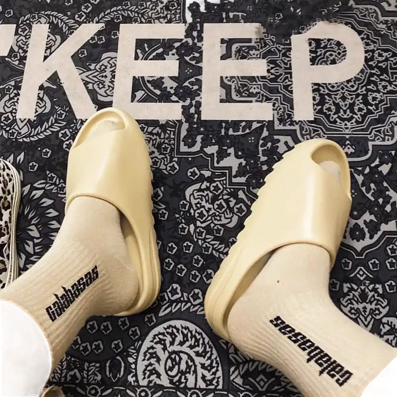 Beige slides with socks.