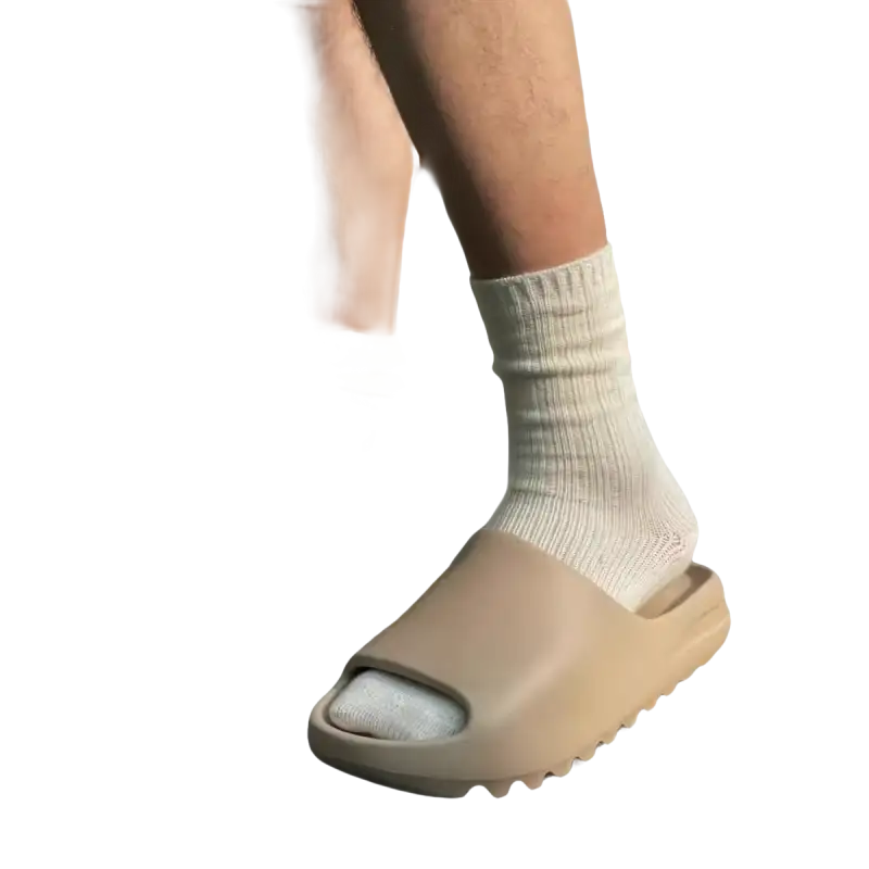 Tan-colored slide sandals with white socks.