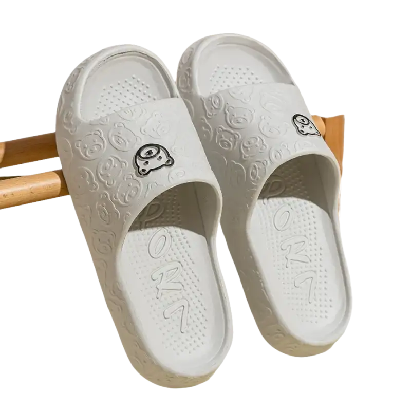 White cartoon-patterned slide sandals.