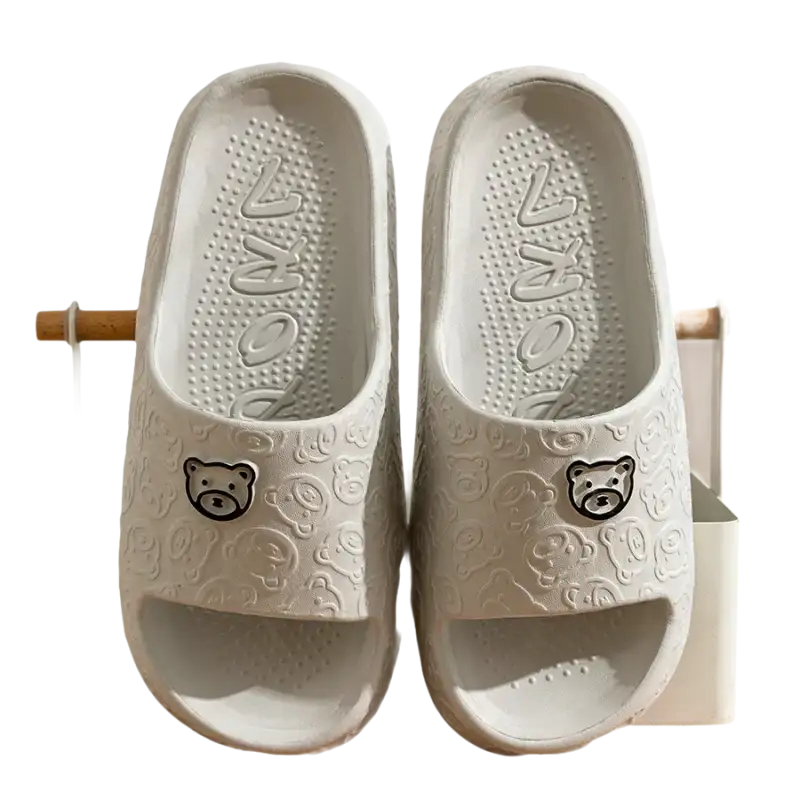 Pair of gray bear-themed slide sandals.