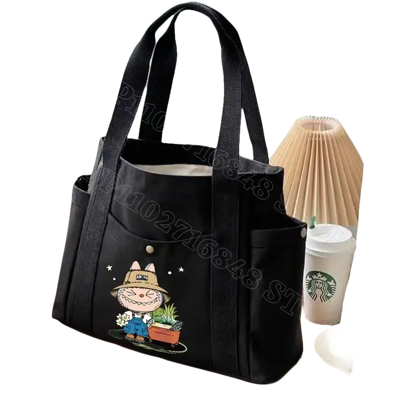 Black canvas tote bag with cartoon design.