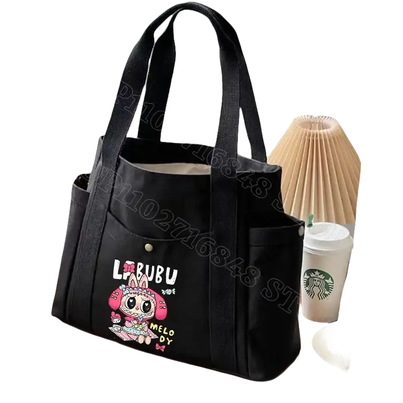 Black canvas tote bag with cartoon graphic.