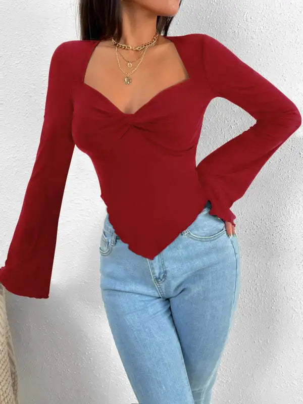 Burgundy long-sleeve top with sweetheart neckline.