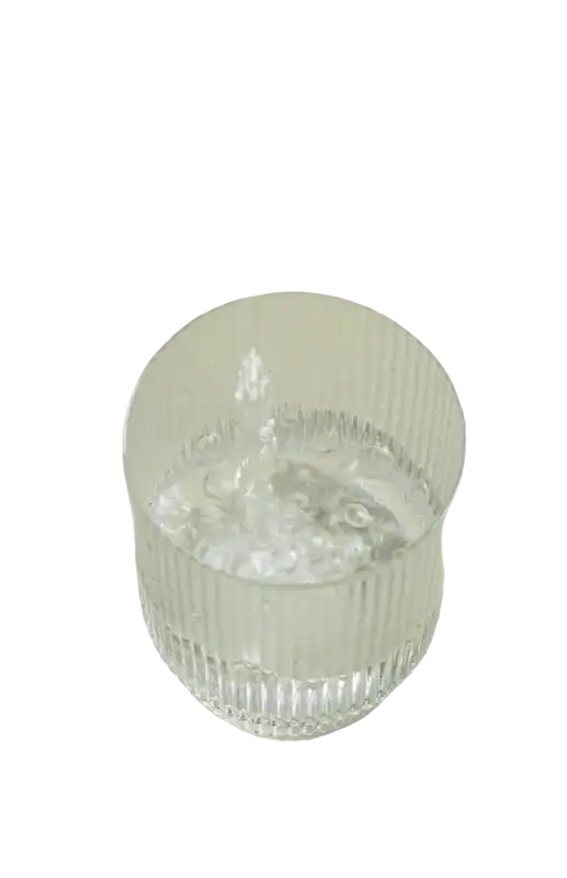 Ribbed glass being filled with water.