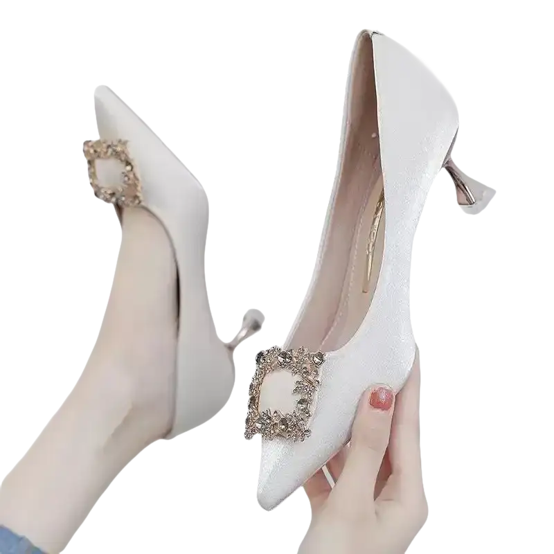 Elegant white high heels with jeweled buckle.