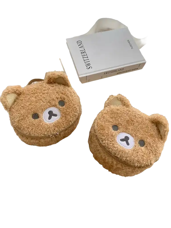 Two fuzzy brown bear-shaped purses.
