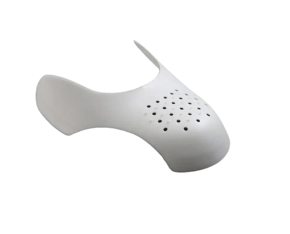 White shoe shield with ventilation holes.