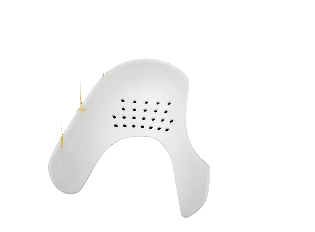 White shoe shield with ventilation holes.