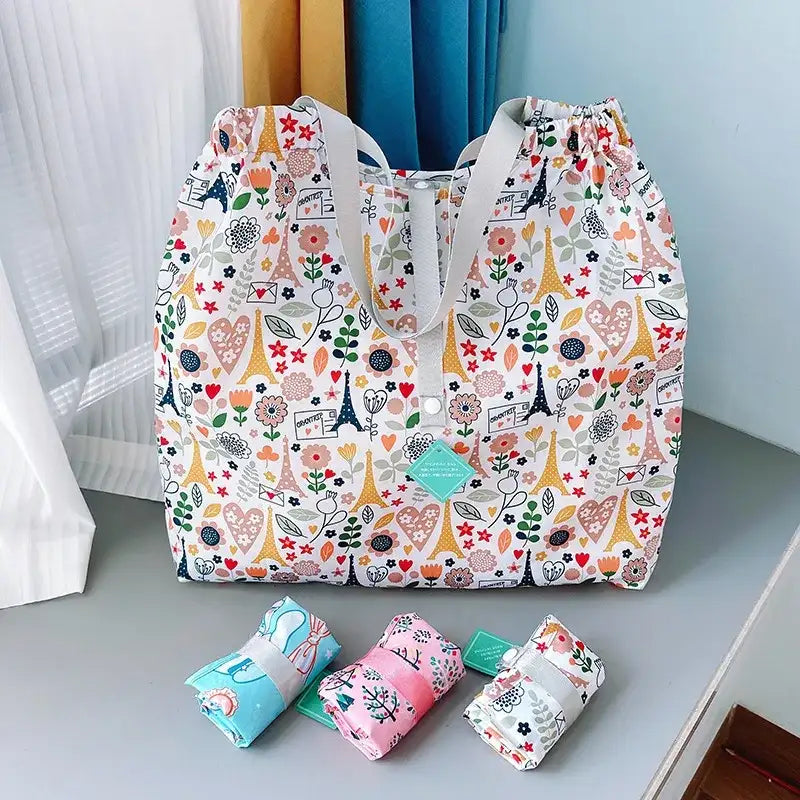 Floral-patterned tote bag with rolled-up matching blankets.