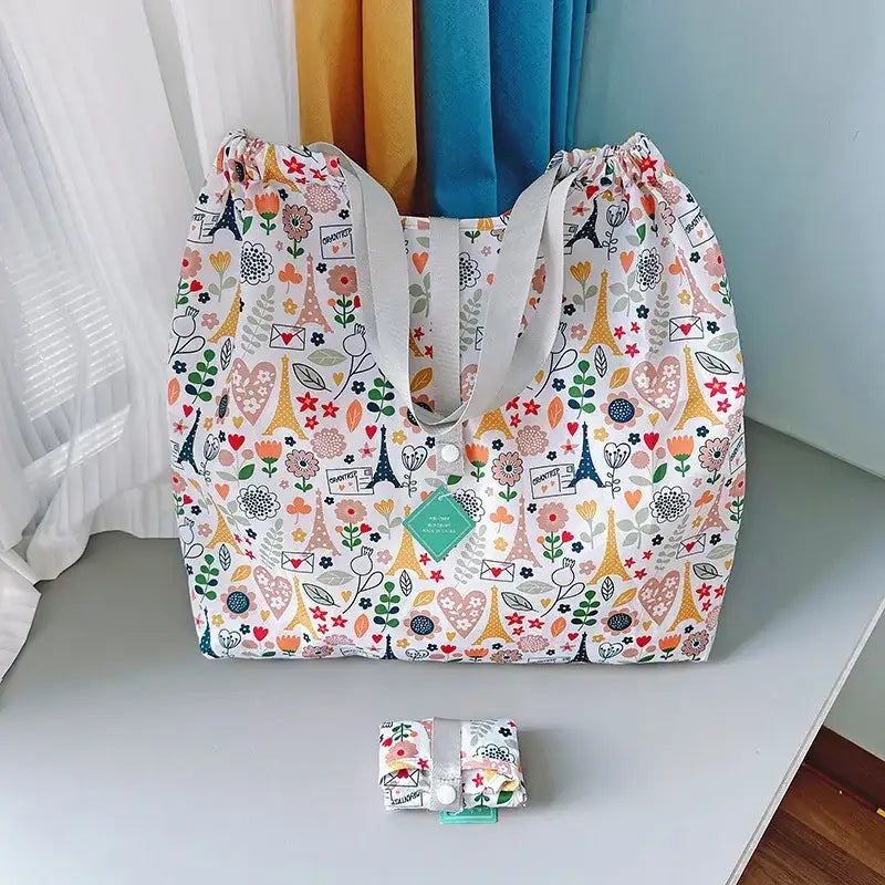 Patterned tote bag with gray straps.