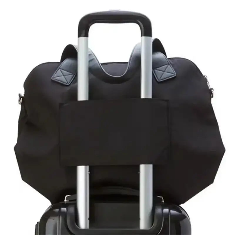 Black duffel bag on luggage.