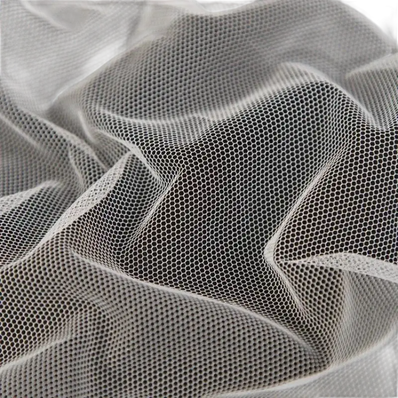 Crumpled white hexagonal mesh fabric.