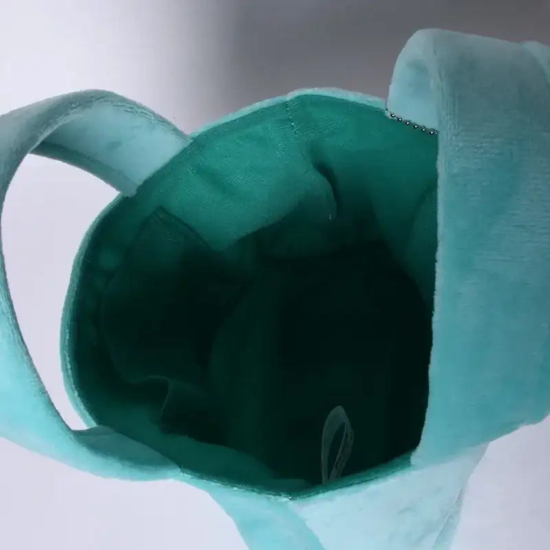 Open turquoise plush tote bag.