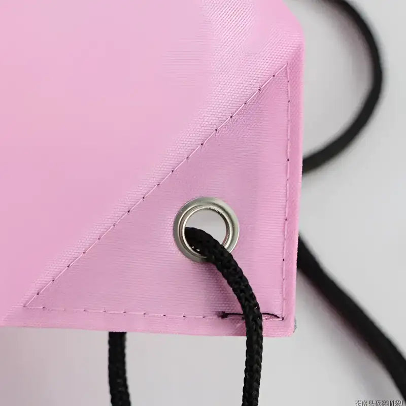 Pink drawstring bag corner.