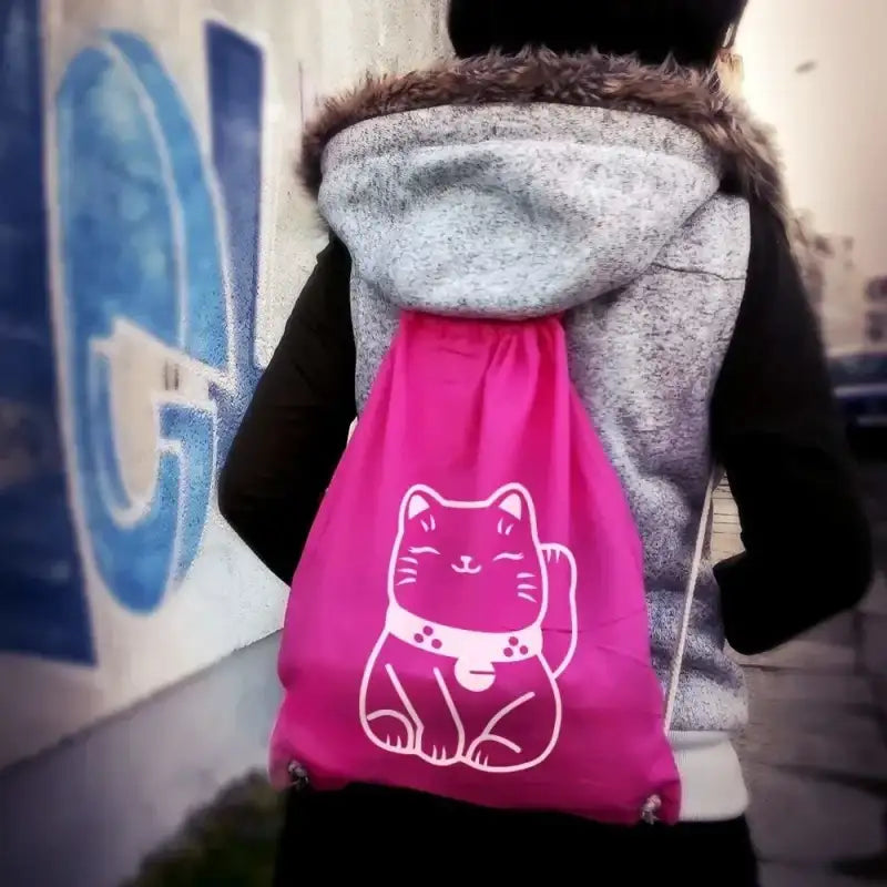 Pink drawstring bag with a white cat design.