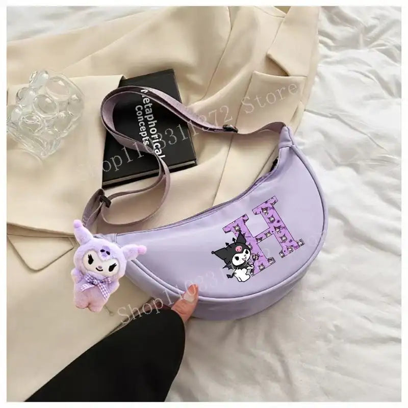Lavender crescent-shaped purse with cartoon character and letter H.