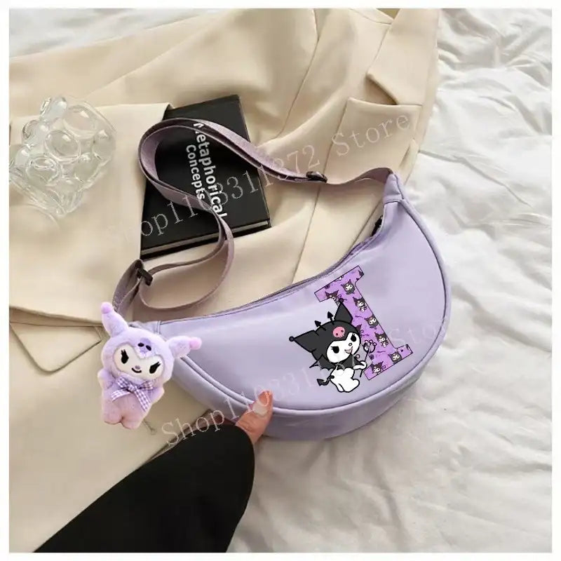 Lavender crescent-shaped purse with cartoon character and plush charm.