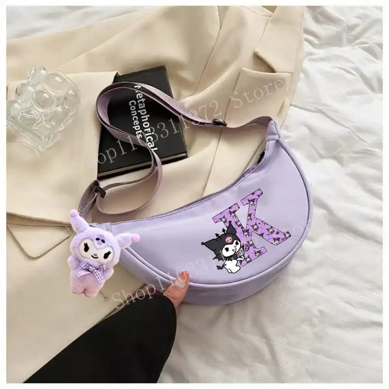 Lavender crescent-shaped purse with cartoon character and plush charm.