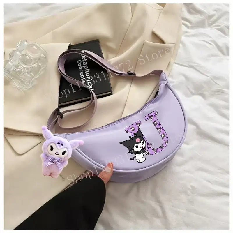 Lavender crescent-shaped purse with cartoon character and plush charm.