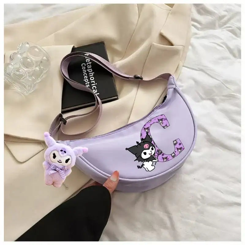 Lavender crescent-shaped purse with cartoon character and plush charm.