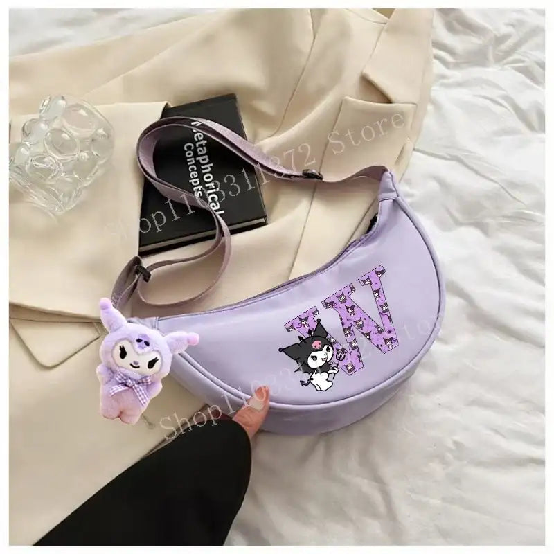 Lavender crescent-shaped purse with cartoon character and plush charm.