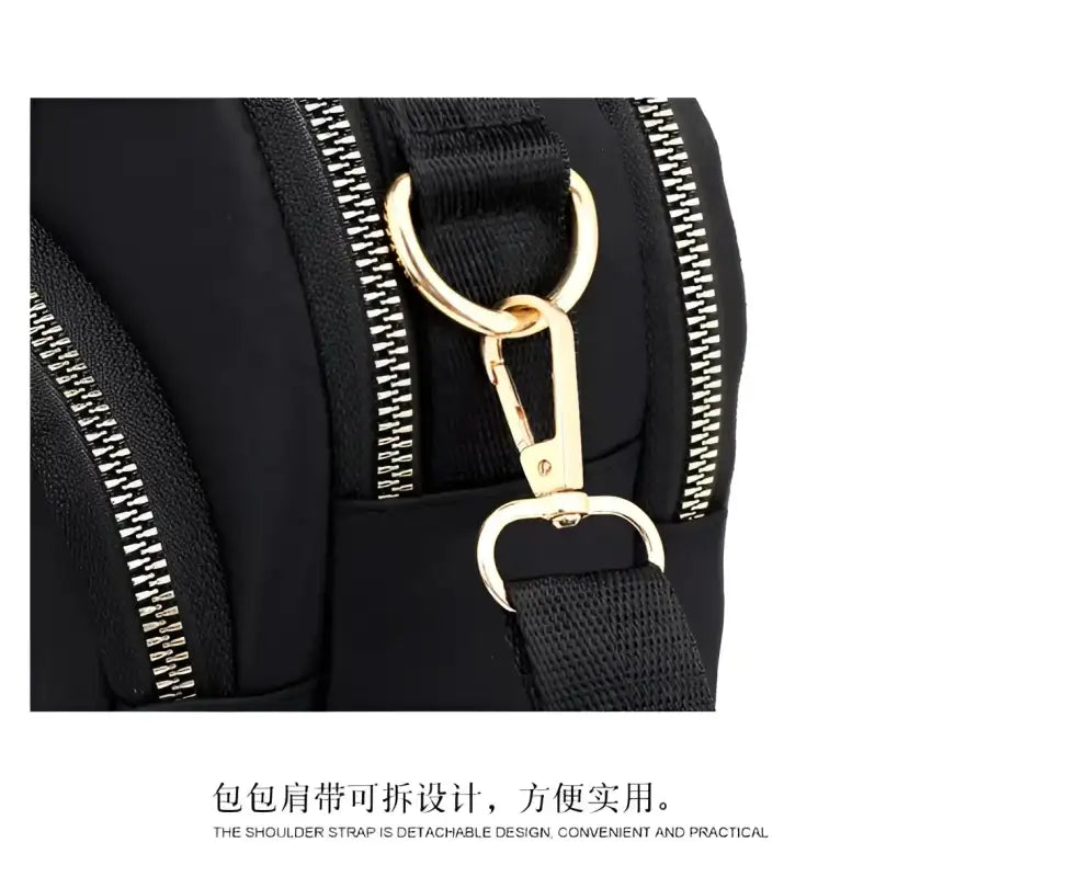 Black nylon bag with gold hardware.