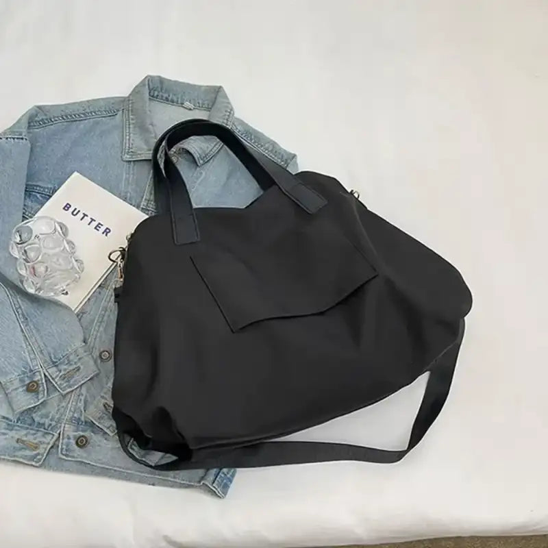 Black tote bag with shoulder strap.
