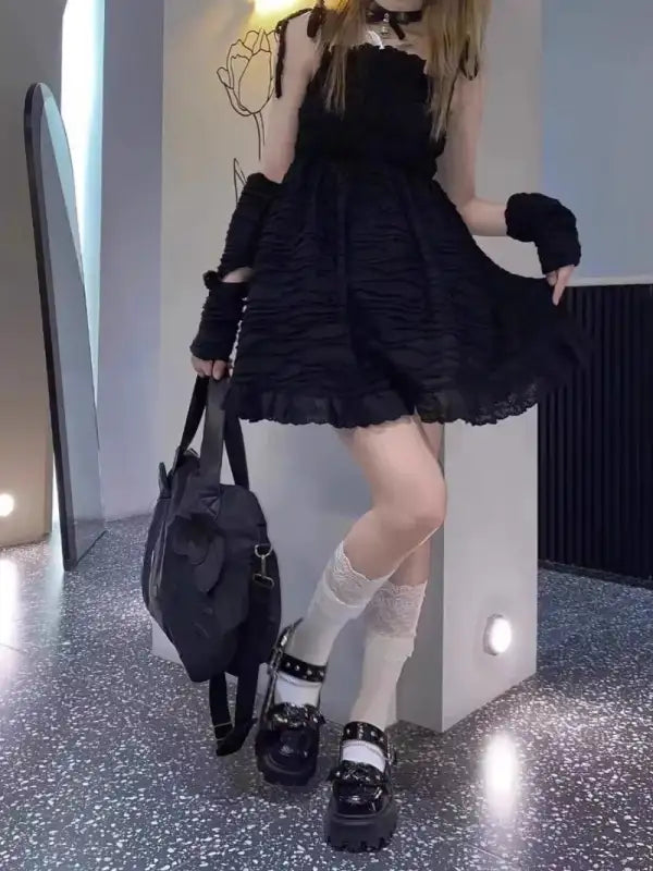 Black ruffled dress with arm warmers.