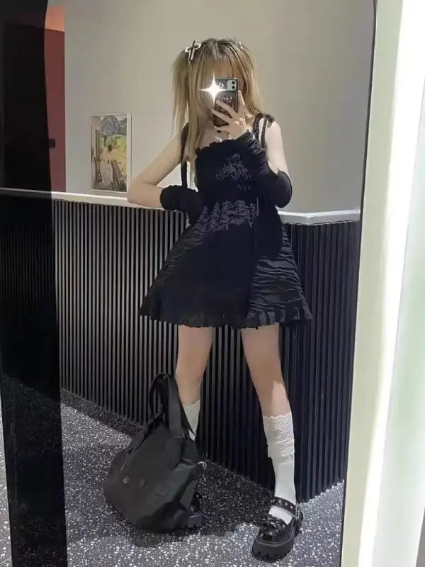 Black textured dress with ruffled hem.